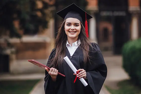Smiling international student holding books 
